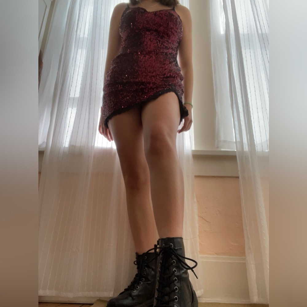Black and red sequin mini dress with lacing on bottom and chest.